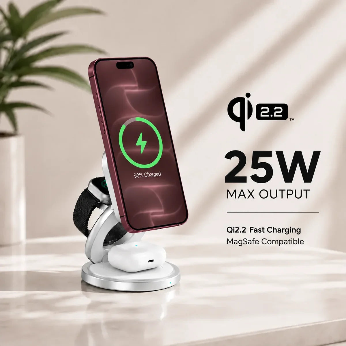 Arctic White rotating foldable wireless charger charging a Burgundy phone, watch and earbuds on a table. #color_Arctic White