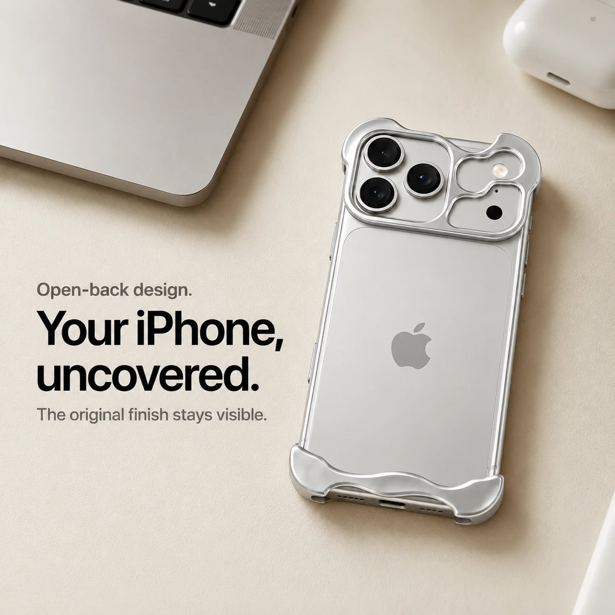 Silver sculpted metal phone case on a desk showing the open back #color_Titanium Silver